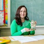 teacher holding a trophy
